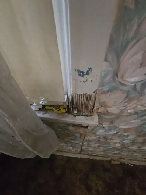 Rotted wall below a window
