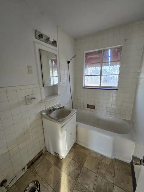 Bathroom with the toilet removed and old tile