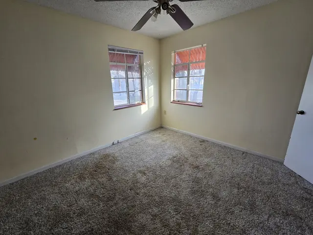 Bedroom with stained carpet