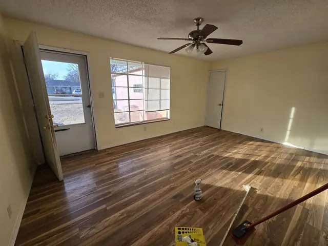Living room with worn laminate flooring