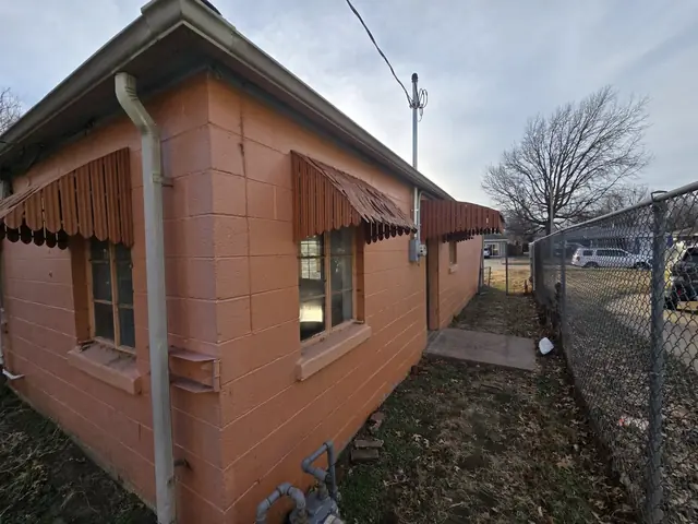 Side of the house with old metal awnings