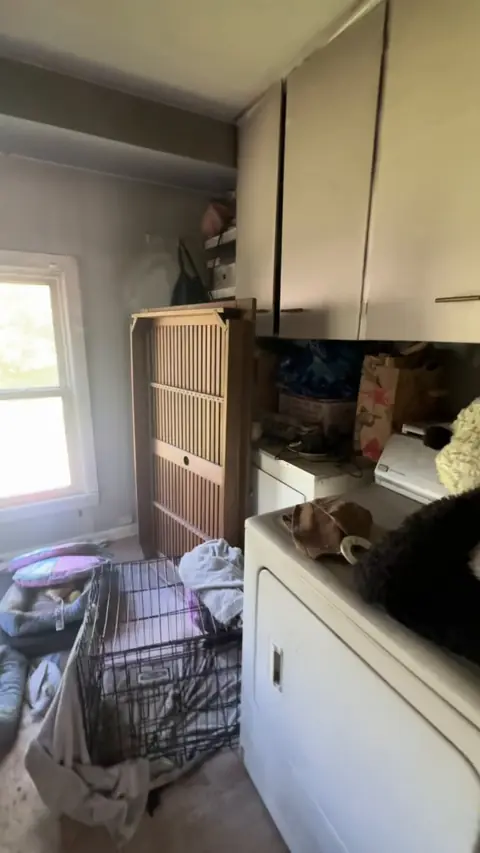 Laundry room with soot on the walls and cabinets